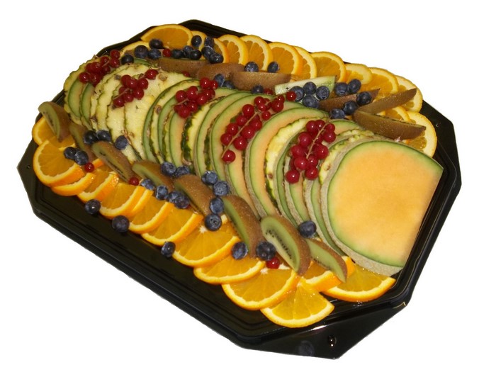 Fruit platter with oranges, pineapple, melon, kiwi, blueberries, and currants