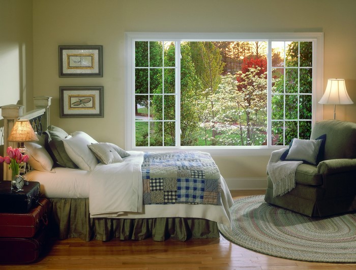 Bedroom with a large window overlooking a garden