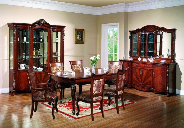 Dining room with wooden table, chairs, and cabinets