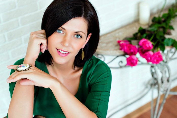 Brunette girl with blue eyes and a ring