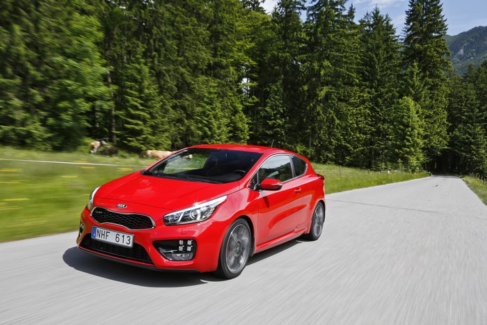 Red 2013 Kia Pro Ceed GT driving on a road