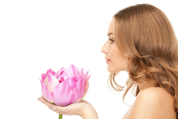Woman holding a pink lotus flower