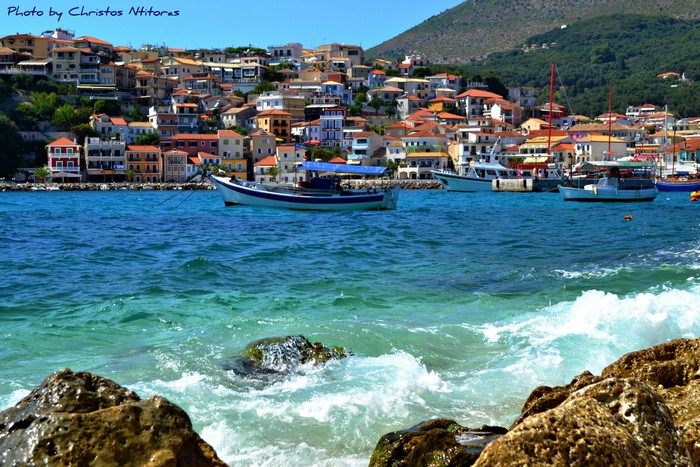 Boats in a bay with a town in Greece
