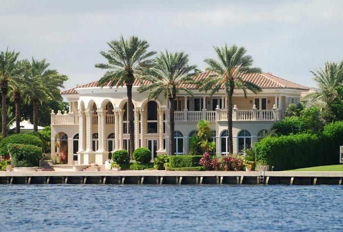 Luxury waterfront mansion with palm trees in Miami