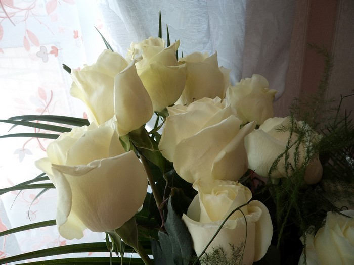 Bouquet of white roses with greenery