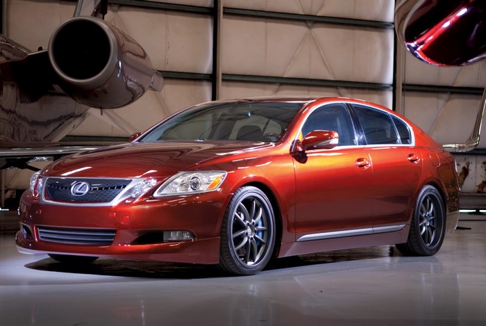 2009 Lexus GS 350 F-Sport parked near a jet
