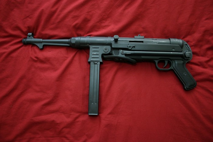 MP 40 submachine gun on red fabric