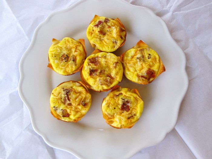 Mini quiches with bacon on a white plate