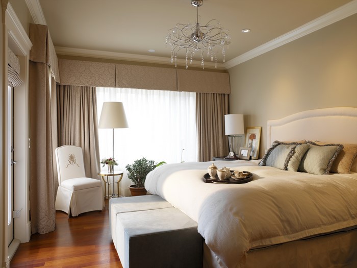 Elegant bedroom with chandelier and large window