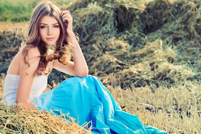 Young woman with brown hair in a blue dress