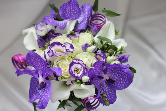Purple orchids and white roses bouquet