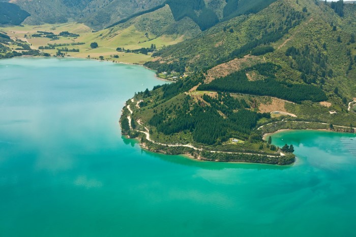 Turquoise lake and green hills in New Zealand