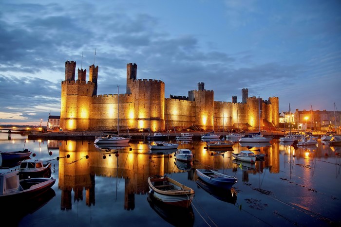 Caernarfon Castle and boats at dusk