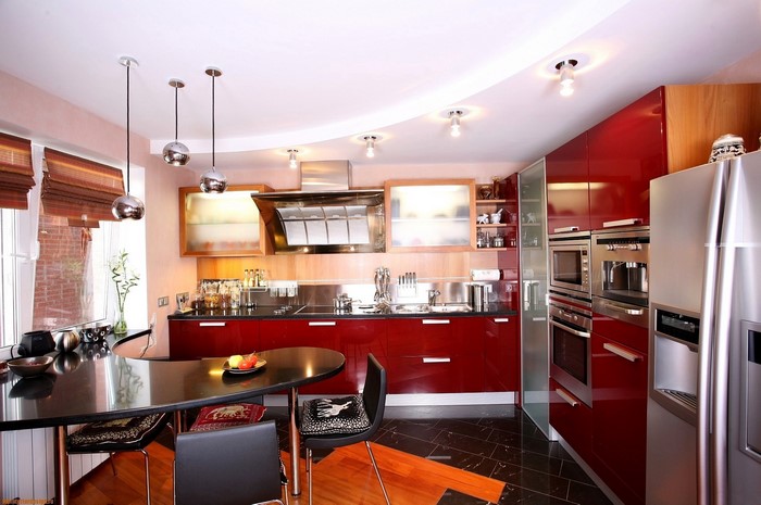 Modern red and stainless steel kitchen with dining table