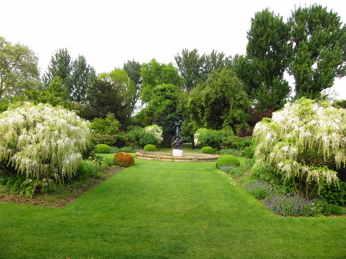 Garden with fountain and blooming trees in London