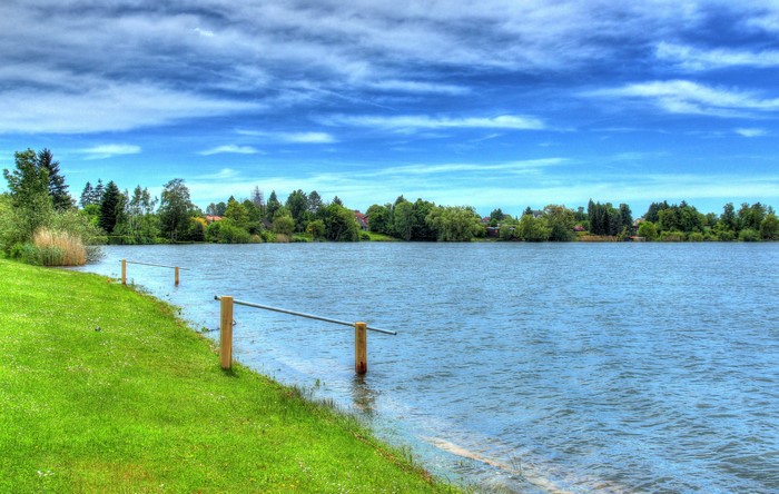 Lake with green shore and trees in Hungen, Germany