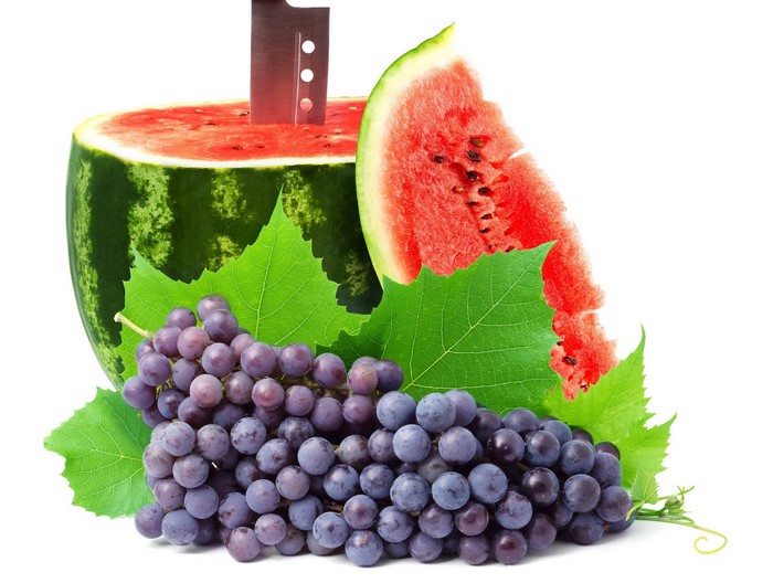 Watermelon slice and grapes with leaves