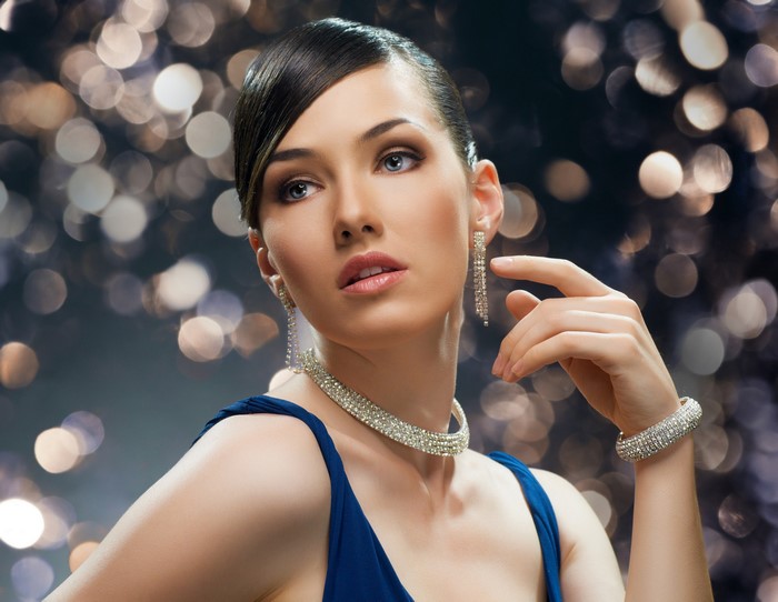 Woman with diamond jewelry and blue dress