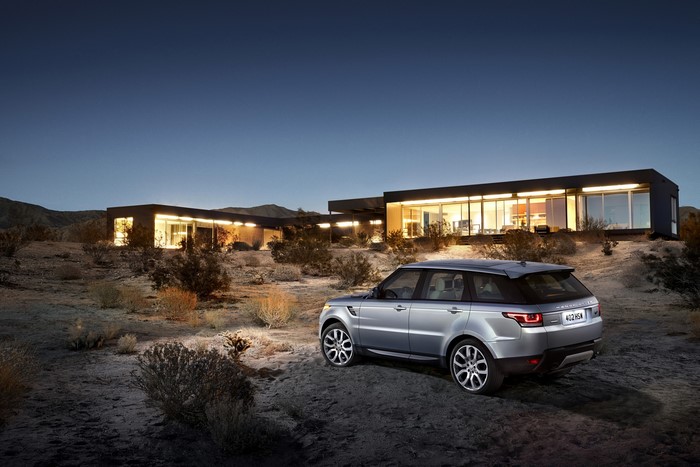 Silver 2014 Range Rover Sport parked near modern house