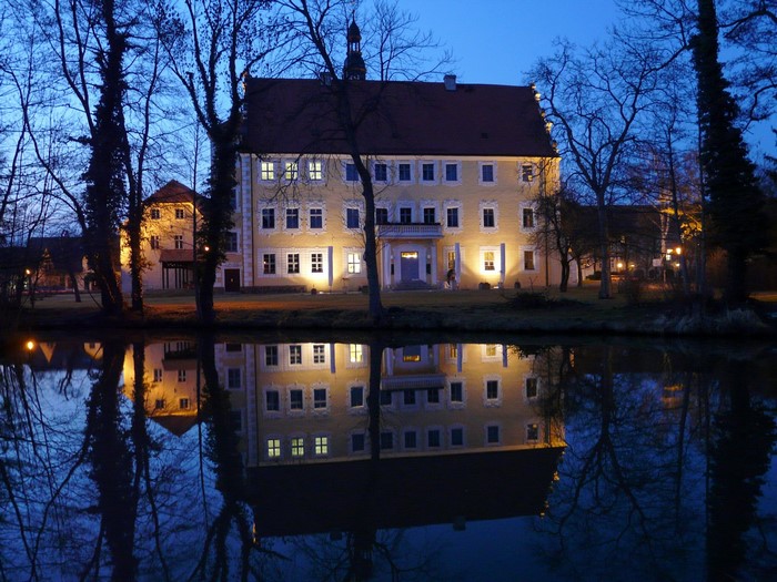 Castle reflected in water at dusk