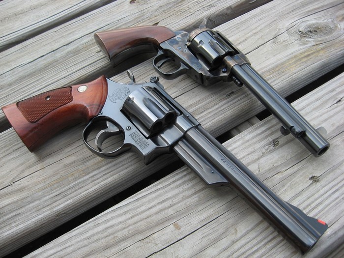 Closeup of Two Classic Revolvers on Wooden Surface