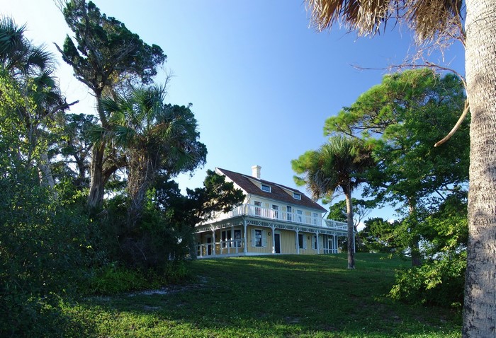 Yellow Mansion surrounded by trees in Oak Hill, Florida