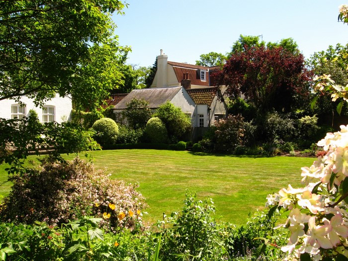 English garden with houses and manicured lawn