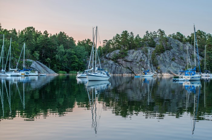 Sailboats docked in a rocky bay in Sweden