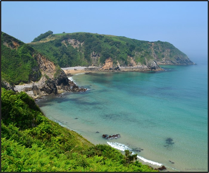 Green cliffs meet turquoise sea in Cantabria, Spain