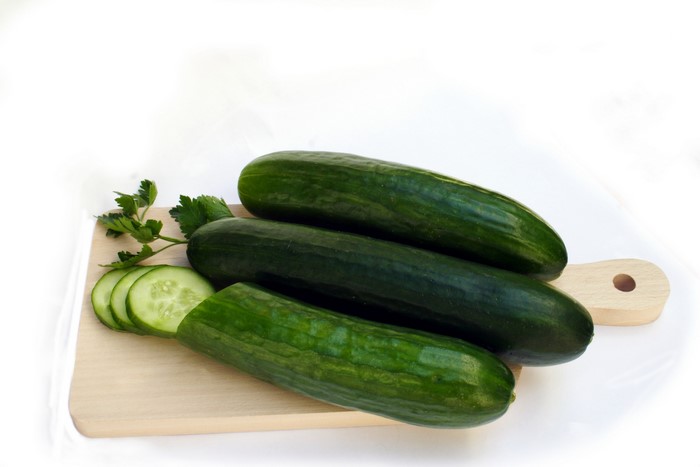 Cucumbers and parsley on a cutting board