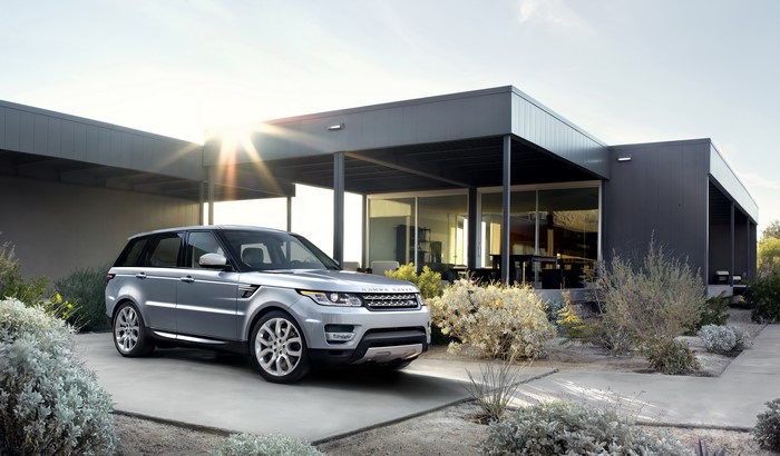 Silver 2014 Range Rover Sport parked at modern mansion
