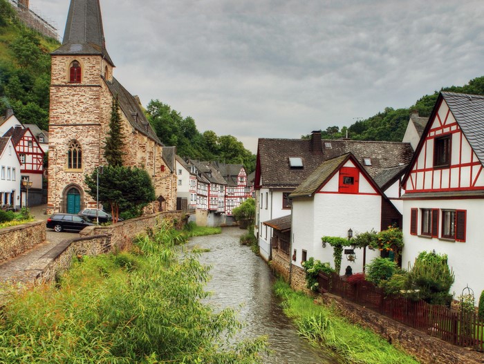 River flowing through a German village with a church