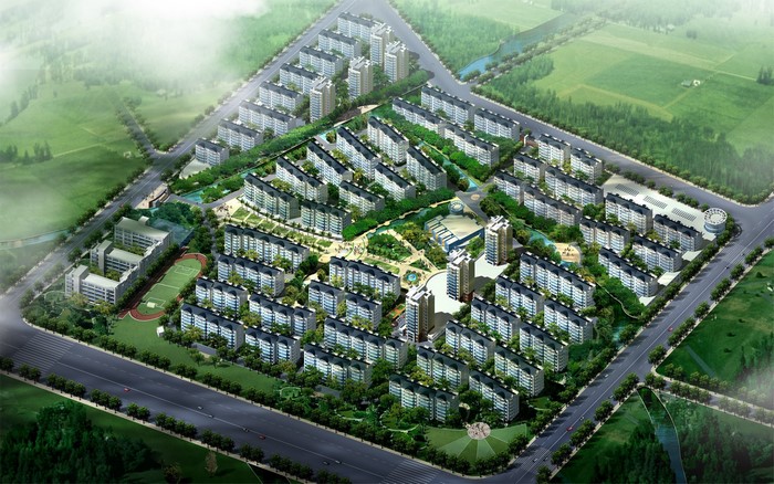Aerial view of a residential complex with apartment buildings and green spaces