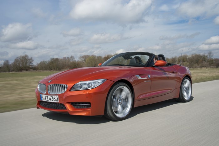 Orange 2013 BMW Z4 Cabriolet driving on a road