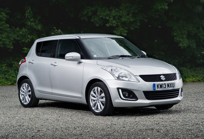 Silver Suzuki Swift parked on gravel