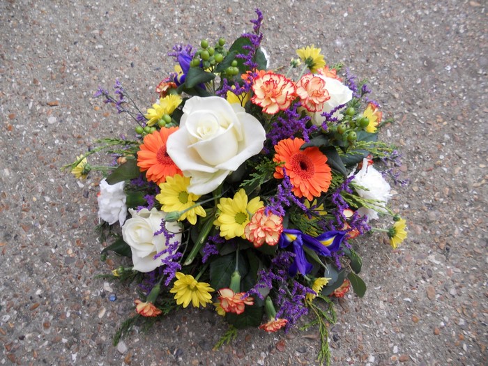 A colorful bouquet of roses, gerberas, and irises