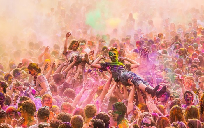 People celebrating Holi festival with colored powder