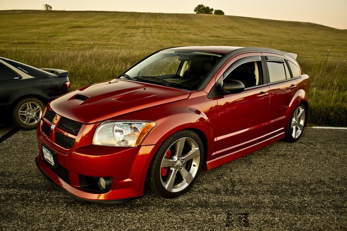 Red Dodge Caliber SRT-4 parked on a road