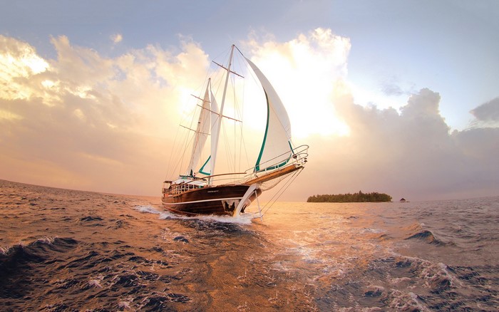 Sailboat sailing on the sea at sunset