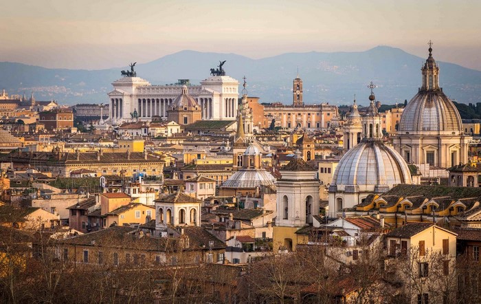 Rome cityscape with historic buildings and mountains