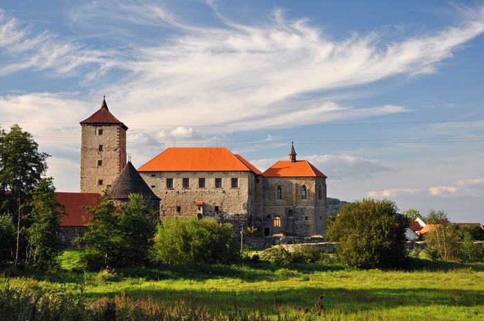 Castle with orange roofs and tower in Czech Republic
