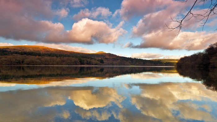 Lake with reflection of clouds and hills