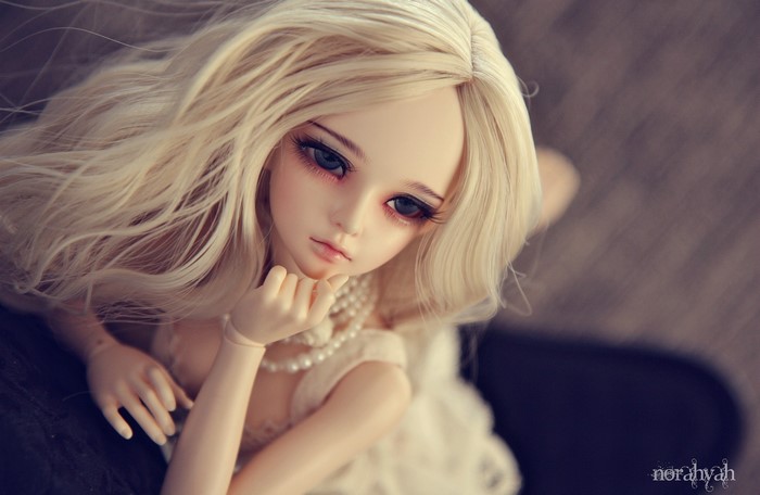 Blonde doll with pearl necklace