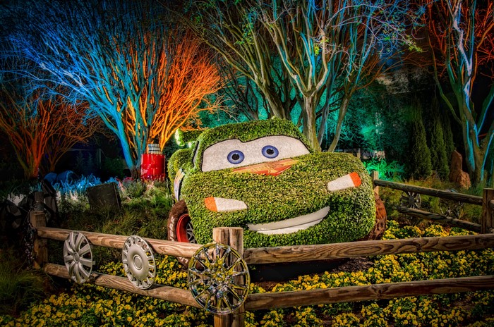 Lightning McQueen topiary in a garden at night
