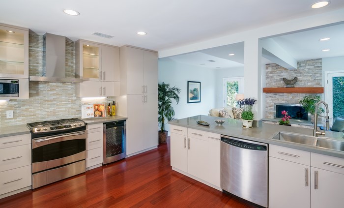 Modern kitchen with stainless steel appliances and hardwood floors