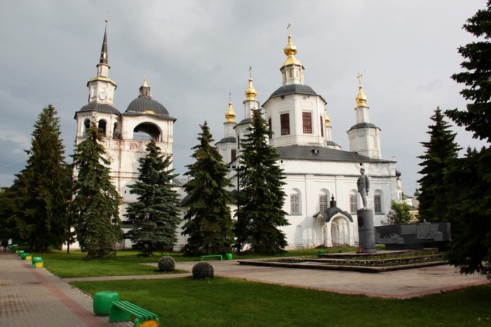 White Orthodox Church with Golden Domes and Bell Tower in Russia