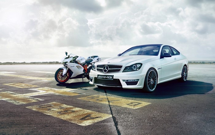 White Mercedes-Benz C63 AMG and Ducati 848 on tarmac