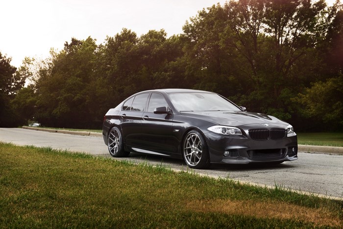 Black BMW 550i F10 on Grass