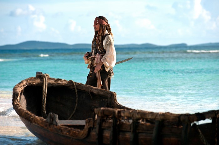 Captain Jack Sparrow from Pirates of the Caribbean on a beach with a boat