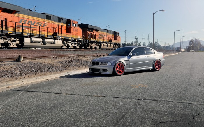 Silver BMW M3 Coupe with Red Wheels and BNSF Train